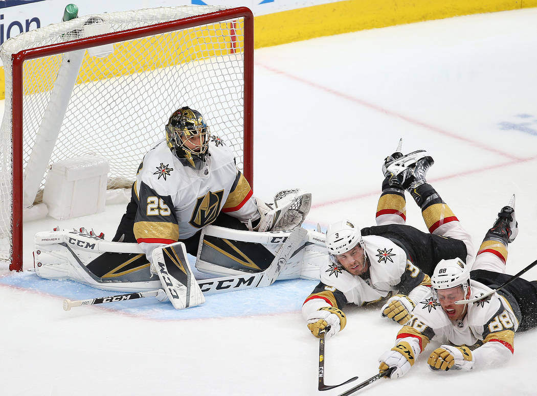 Golden Knights goaltender Marc-Andre Fleury (29) makes a save with the help of Knights defensem ...