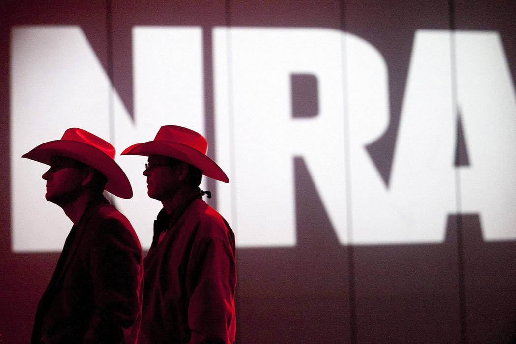 FILE - In this May 4, 2013, file photo, National Rifle Association members listen to speakers d ...
