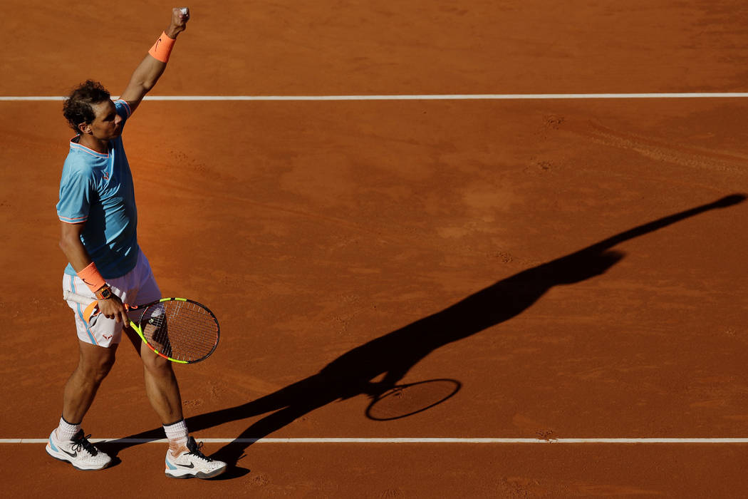 Spain's Rafael Nadal raises his arm after winning his men's singles match against Argentina's L ...