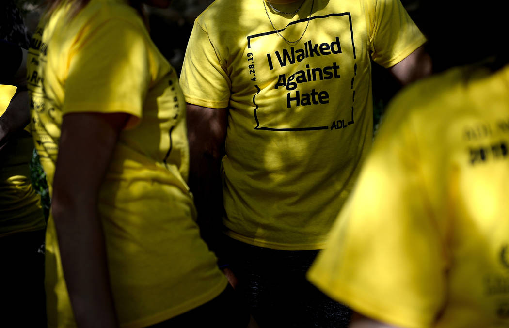 People participating in the Anti-Defamation League Walk Against Hate wear t-shirts for the even ...
