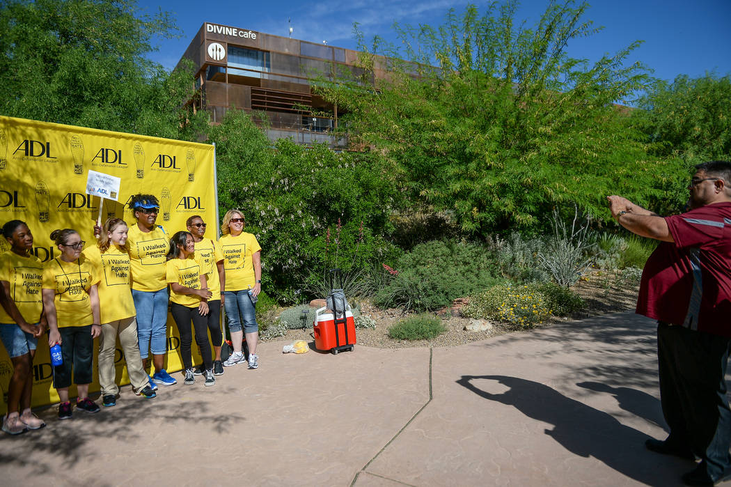 People participating in the Anti-Defamation League Walk Against Hate pose for a photograph at t ...