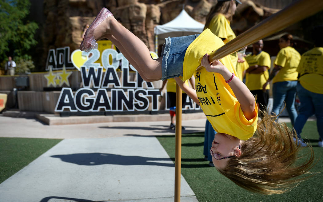 Vayla West, 7, from Las Vegas spins on a railing during the Anti-Defamation League Walk Against ...