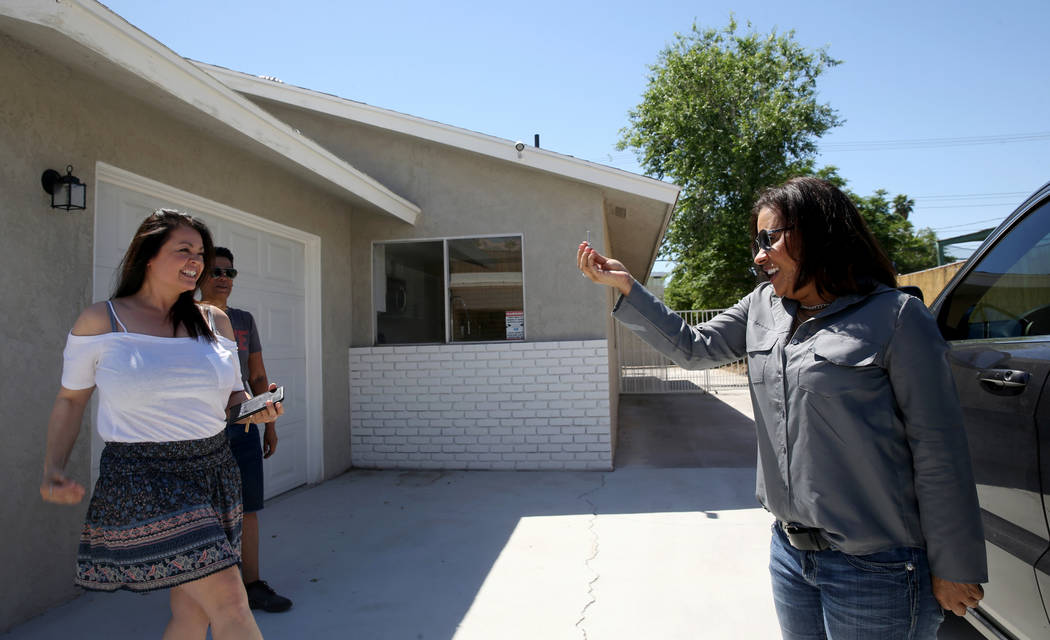 Ana Martinez, a veteran who was homeless two years ago, gets the key to her Las Vegas home from ...