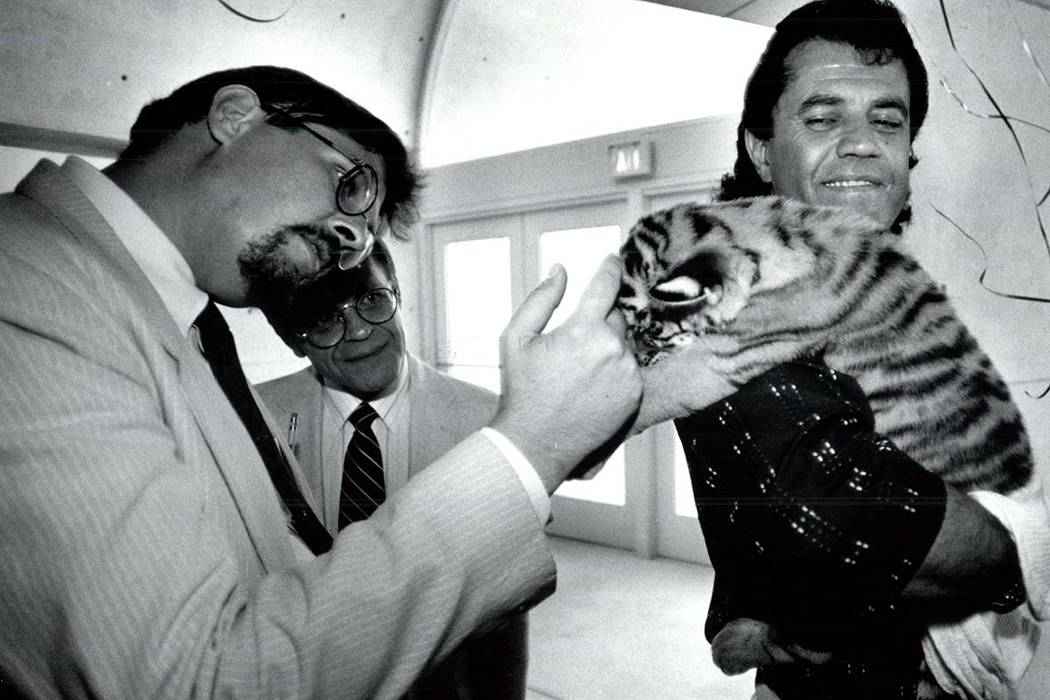 Gary Ogren pets 4-week-old tiger cub, Samantha, held by Jonathan Kraft in a Sept. 24, 1990, pho ...