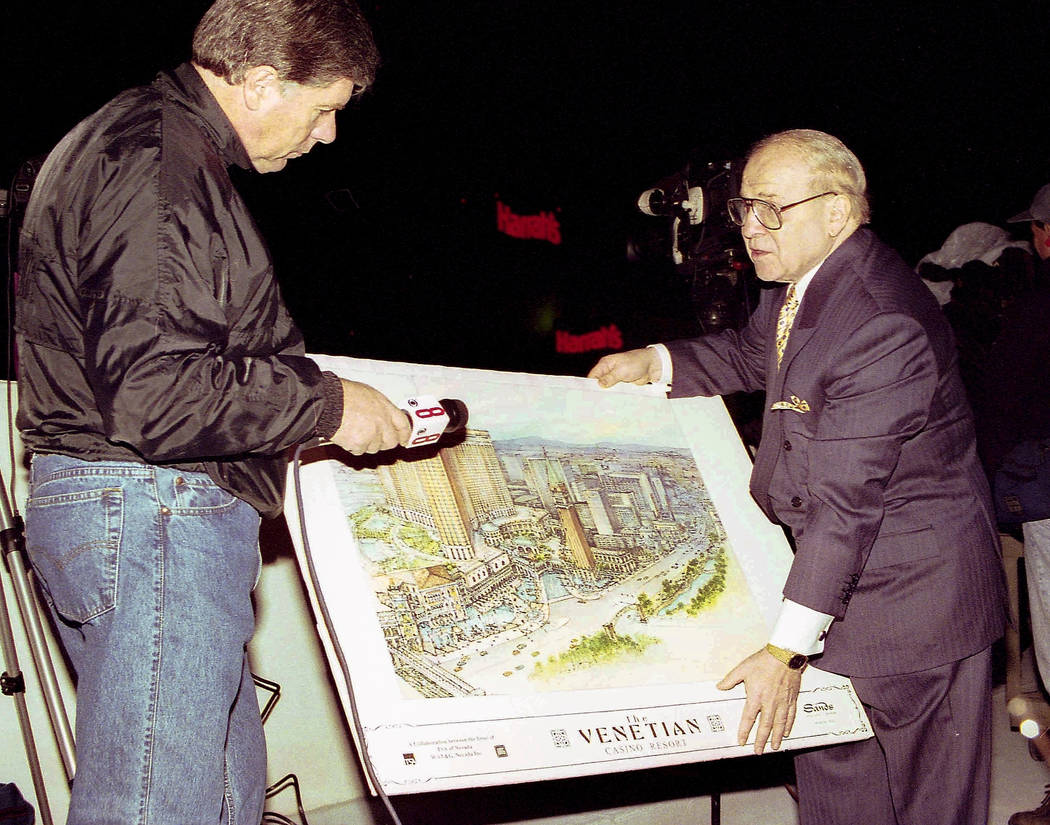 Sheldon Adelson, right, displays a rendering of the Venetian to a reporter on November 26, 1996 ...
