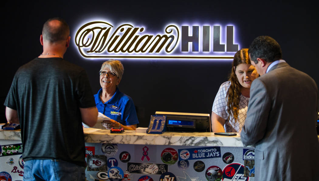 Customers place their wagers at the William Hill Sports Book at the SLS on Monday, April 15, 20 ...