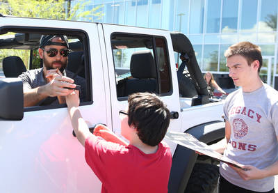 Golden Knights defenseman Deryk Engelland signs autographs for fans outside City National Arena ...