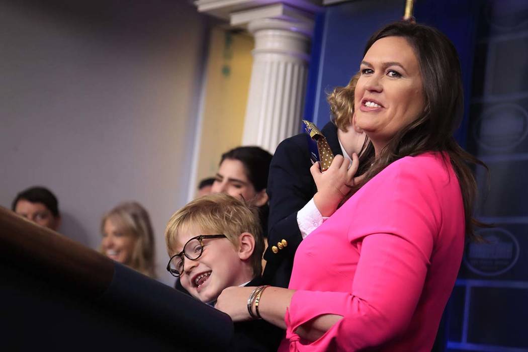 White House press secretary Sarah Huckabee Sanders holding her children Huck Sanders, with eye ...