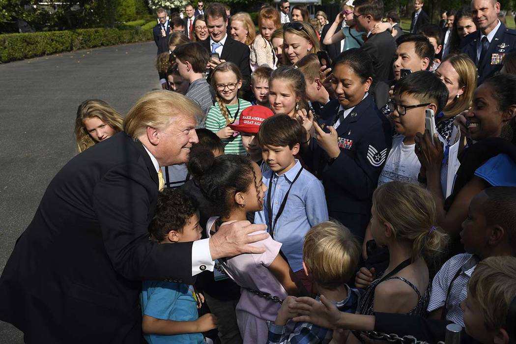 President Donald Trump greets children after speaking to them on the South Lawn of the White Ho ...