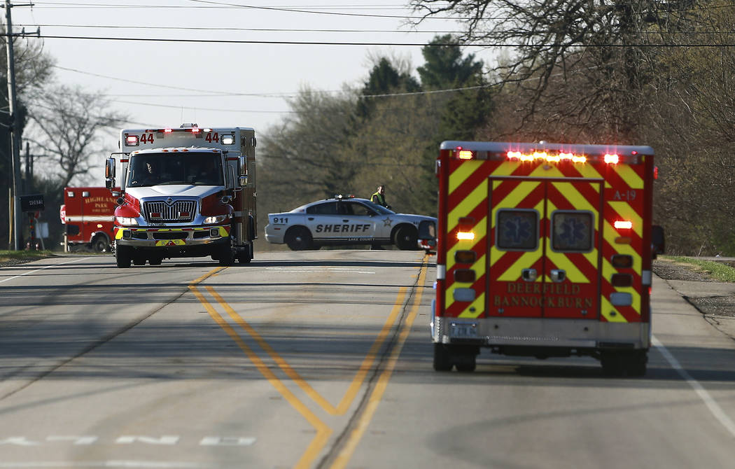 Police and emergency personnel respond to a hazardous materials situation that blocked off road ...