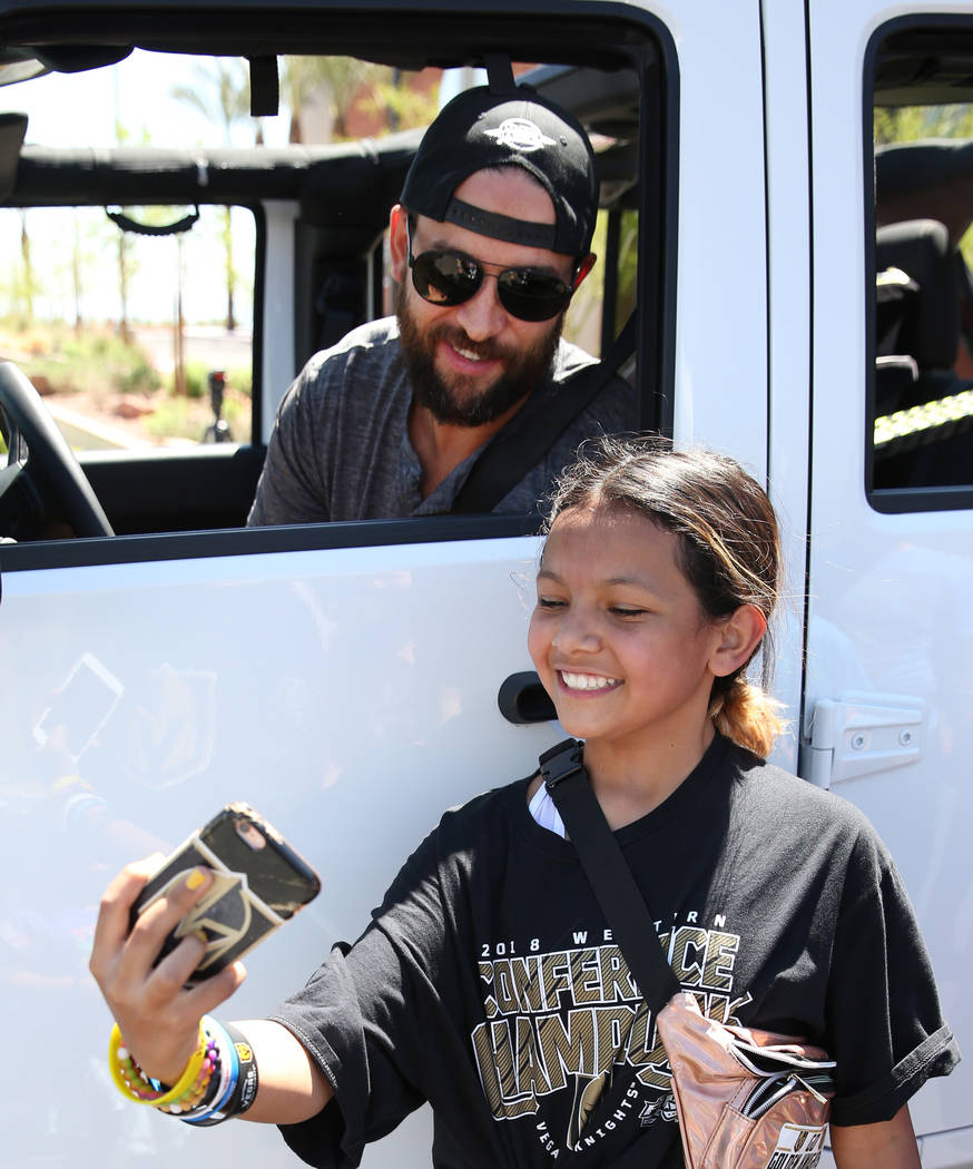 Golden Knights defenseman Deryk Engelland poses for a selfie with Ciera Soto, 11, outside City ...