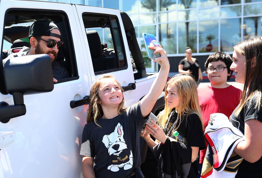 Golden Knights defenseman Deryk Engelland poses for a selfie with fans outside City National Ar ...