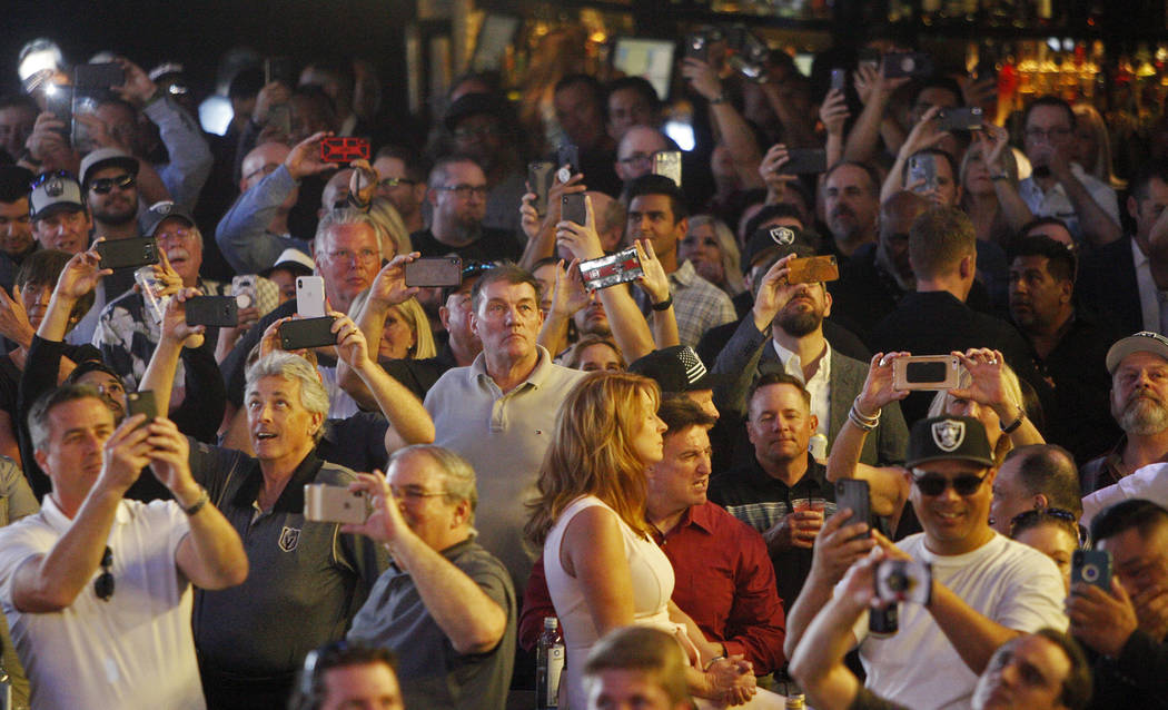 A crowd reacts to the fourth draft pick of Defensive End Clelin Ferrell at a Raiders draft part ...
