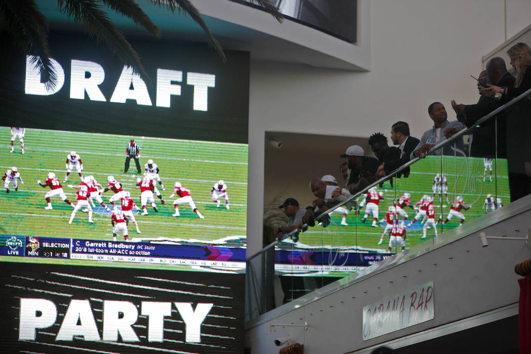 Crowds watch and mingle during a Raiders draft party at Drai's nightclub at The Cromwell hotel- ...
