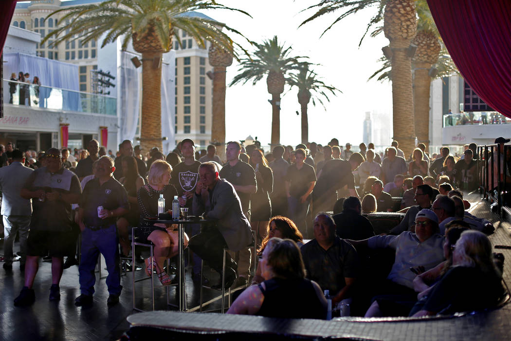 Crowds watch and mingle during a Raiders draft party at Drai's nightclub at The Cromwell hotel- ...