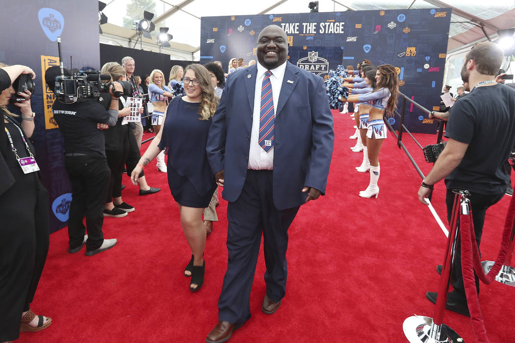 Gregory Hampton, winner of the NFL 100 season ticket giveaway, walks the NFL draft red carpet, ...
