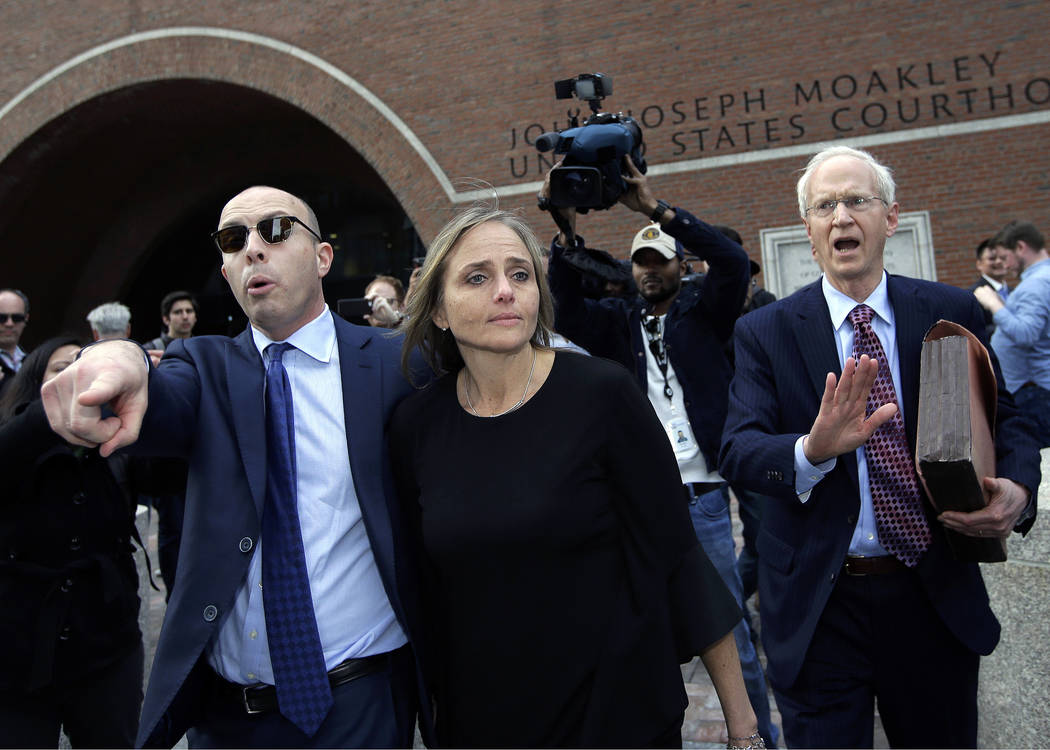 District Court Judge Shelley M. Richmond Joseph, center, departs federal court, Thursday, April ...