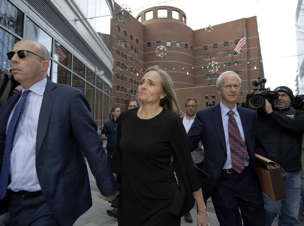 District Court Judge Shelley M. Richmond Joseph, center, departs federal court, Thursday, April ...