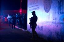 A Federal Police officer stands guard outside an immigration detention center in Tapachula, Chi ...
