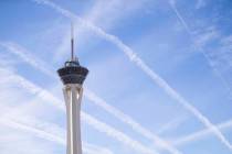 Vapor trails left behind by airplanes are seen above the Stratosphere tower in Las Vegas, Satur ...