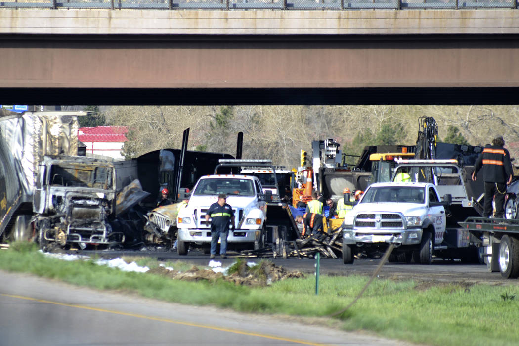 Authorities survey the scene of a fiery crash on I-70 near Colorado Mills Parkway that shut dow ...