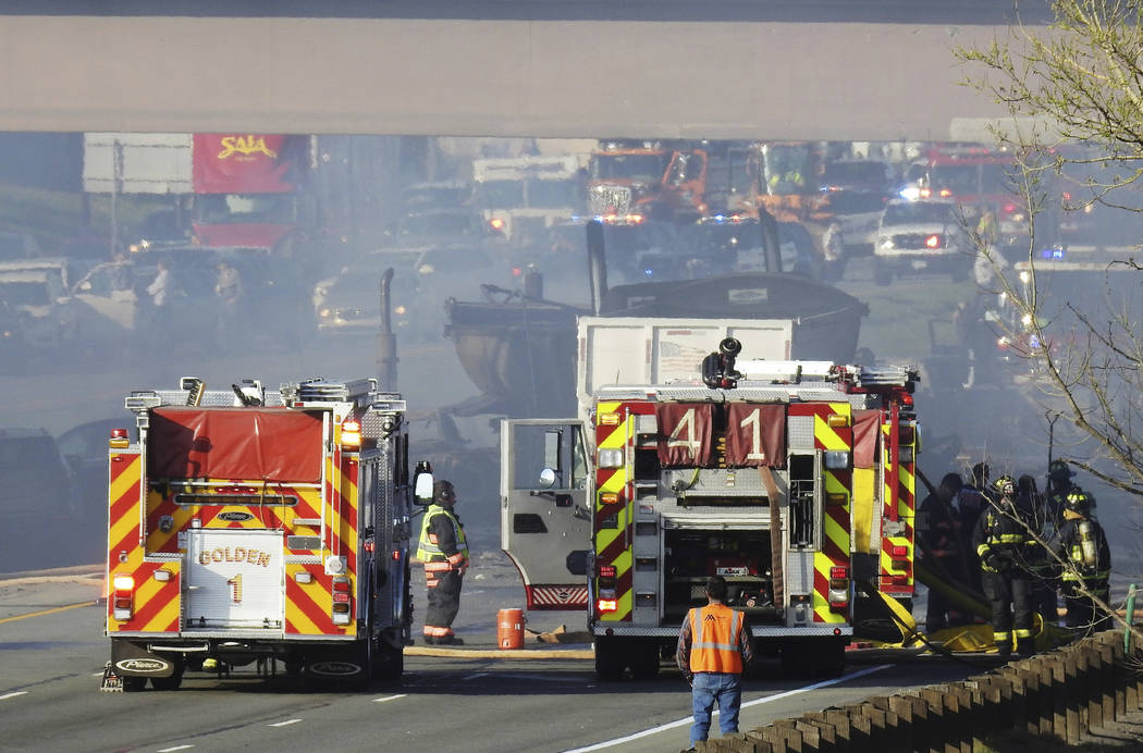 Emergency crews work at the scene of a deadly collision on Interstate 70 near the Colorado Mill ...