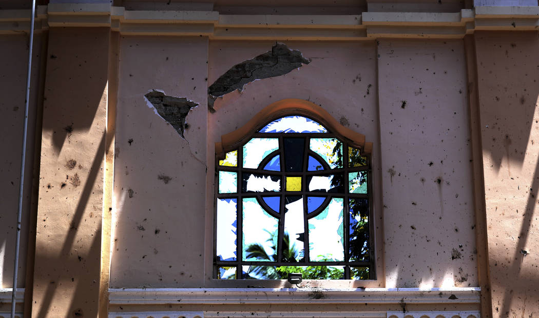 In this Thursday, April 25, 2019 photo, a stained-glass window stands broken at Sebastian's Chu ...