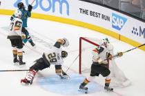 Knights goaltender Marc-Andre Fleury (29) gets turned around after Sharks right wing Barclay Go ...