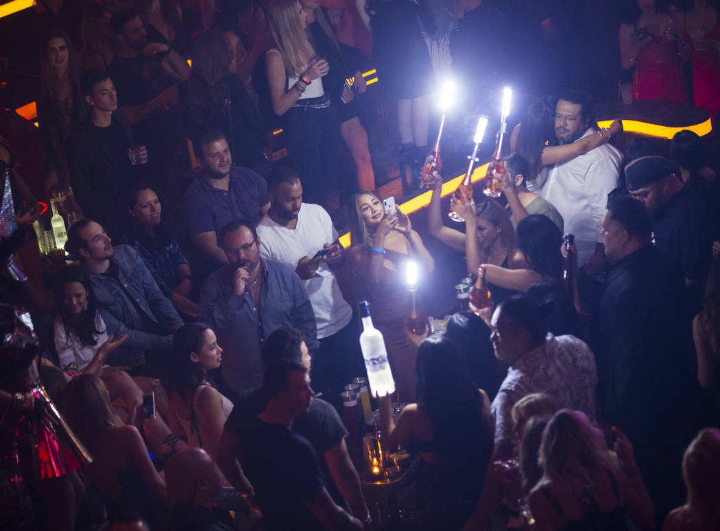 Bottles of alcohol are delivered to a table in the nightclub area during the grand opening week ...
