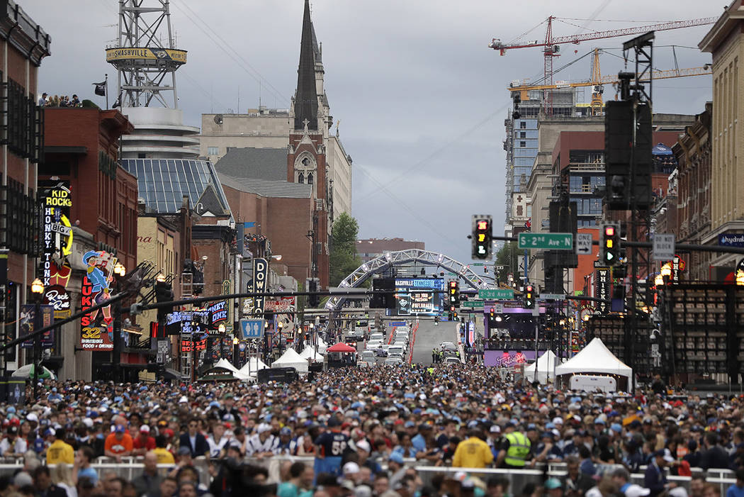 Fans watch the main stage ahead of the first round at the NFL football draft, Thursday, April 2 ...