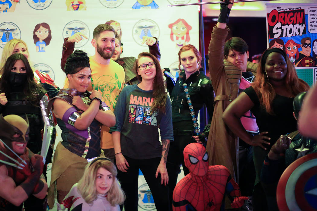 Fans get their photos taken with Critical Care Comics cosplayers before the first showing of "A ...