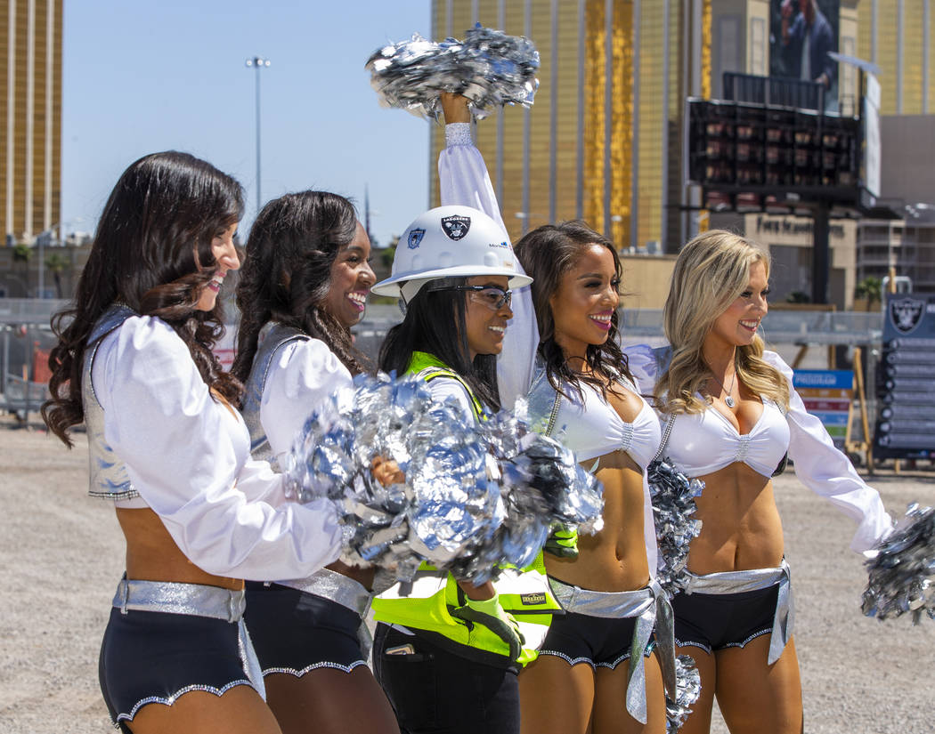 Day laborer Amale Garcia is flanked by the Raiderettes as she helps the Raiders announce their ...