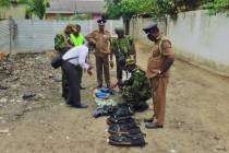 Sri Lankan police and army officers display gelatin sticks, detonators, back packs and other bo ...