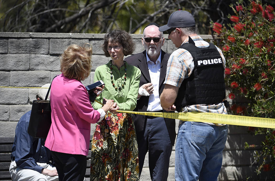 Synagogue members talk to a San Diego County Sheriff's deputy outside of the Chabad of Poway Sy ...