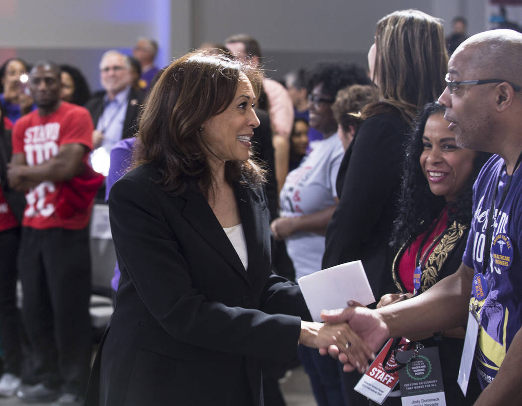 Presidential candidate Sen. Kamala Harris, left, D-Calif., shakes hands with supporters during ...