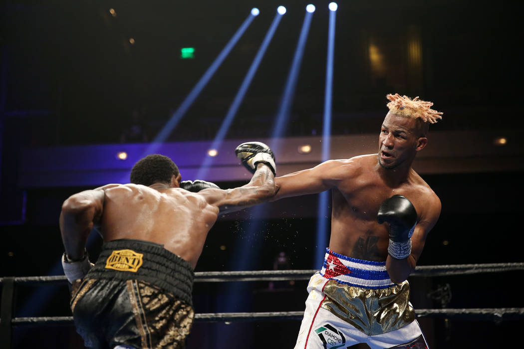 Robert Easter Jr., left, throws a punch against Rances Barthelemy in the WBA lightweight champi ...