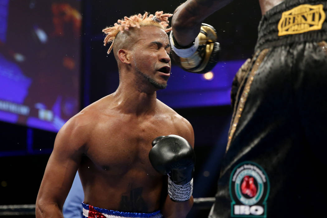 Rances Barthelemy, left, takes a punch from Robert Easter Jr. in the WBA lightweight championsh ...