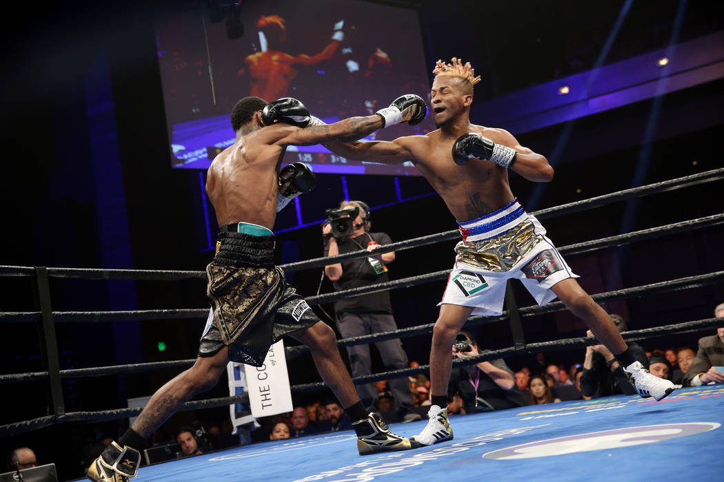 Robert Easter Jr., left, exchanges punches with Rances Barthelemy in the WBA lightweight champi ...