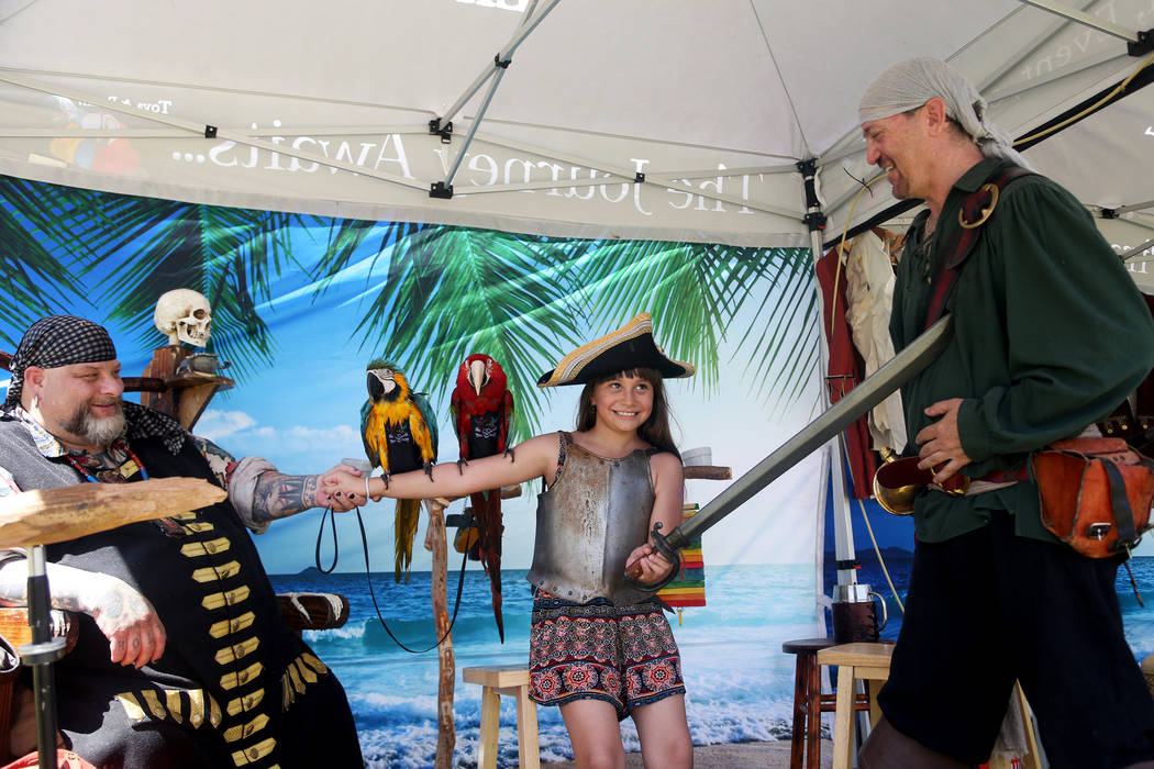 "Captain" Corey Lefkowitz, owner of A Pirate's Life Experience, from left, allows his ...