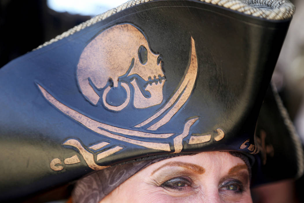 Paula Cottrill shows off her leather pirate hat at the Damsel In This Dress booth at the Pirate ...