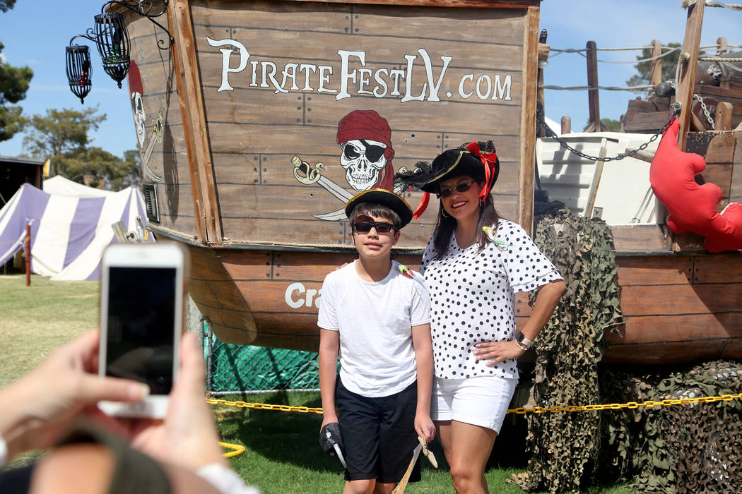 Hilda Puga takes a photo with her son Jose Vasquez, 10, at the Pirate Fest at Craig Ranch Park ...