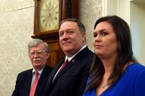 Secretary of State Mike Pompeo, center, flanked by national security adviser John Bolton, left, ...