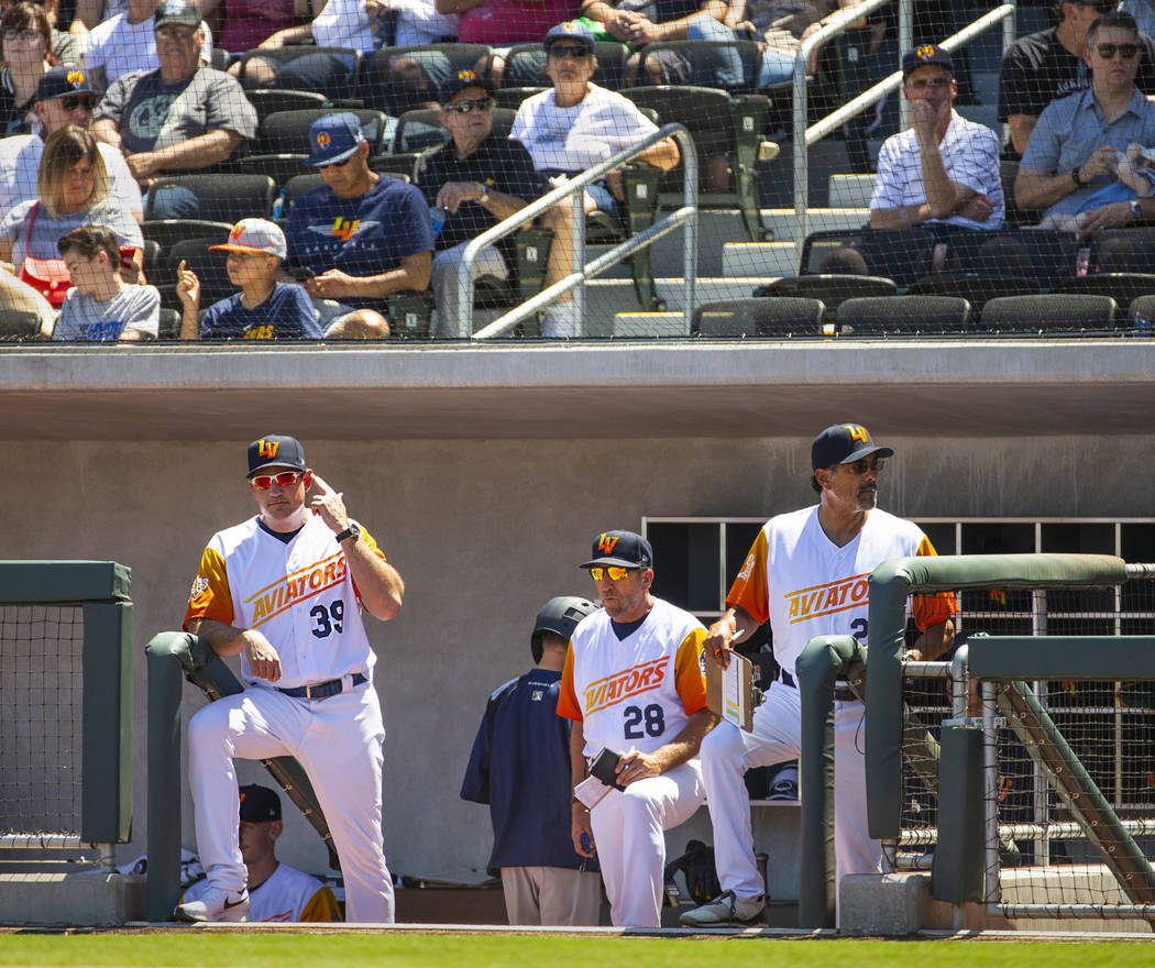 Aviators manager Fran Riordan (39) sends in signals to his batter with coaches Craig Conklin (2 ...