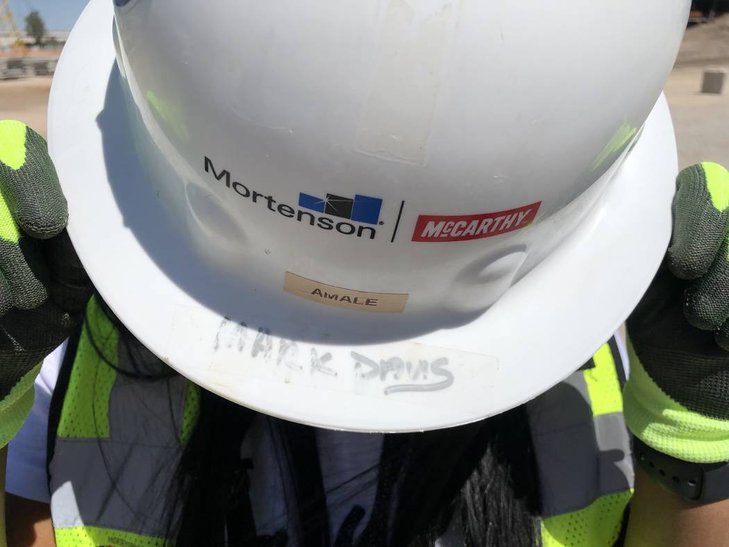 Amale Garcia shows off her work hard hat, signed by Raiders owner Mark Davis, on Saturday, Apri ...