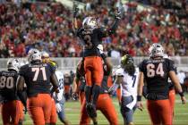 UNLV Rebels running back Lexington Thomas (3) celebrates with teammates after scoring a touchdo ...