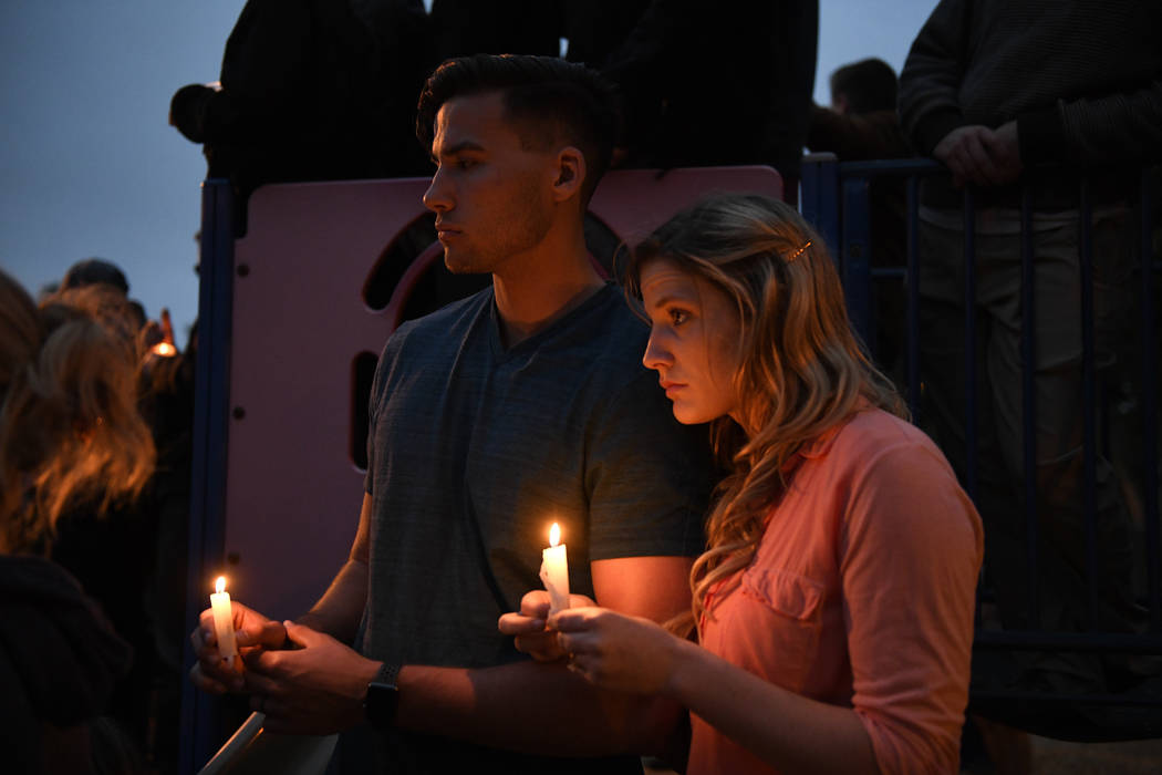 A couple holds candles during a vigil held for victims of the Chabad of Poway synagogue shootin ...