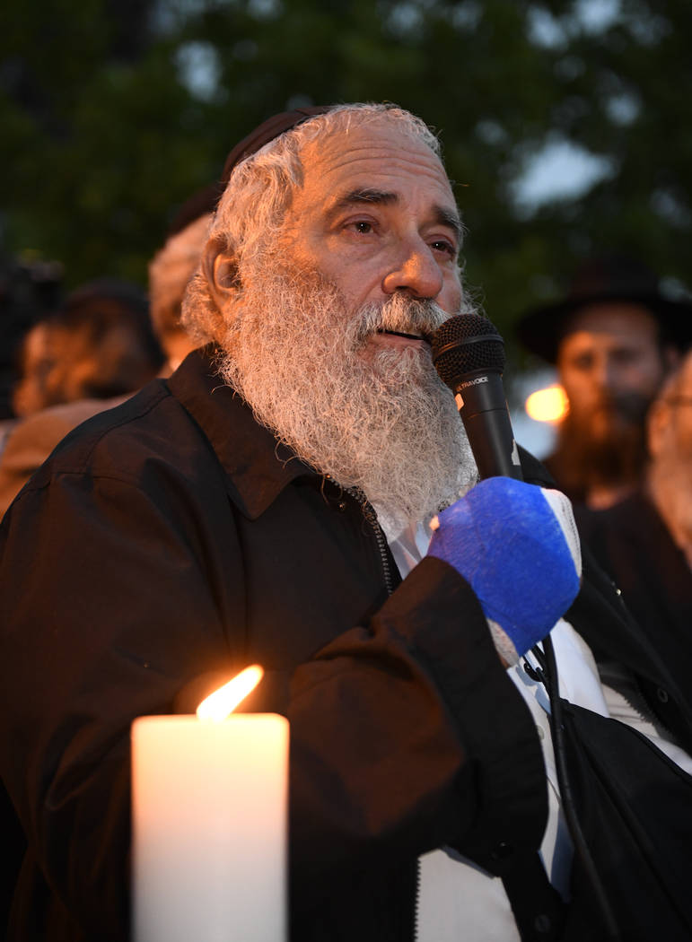 Rabbi Yisroel Goldstein speaks during a candlelight vigil held for victims of the Chabad of Pow ...