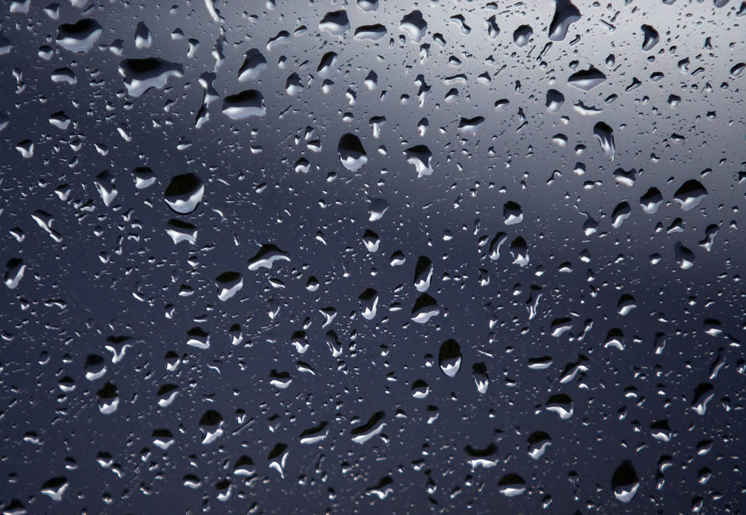 Raindrops gather on a window as a fast-moving storm makes its way through the Red Rock Canyon N ...