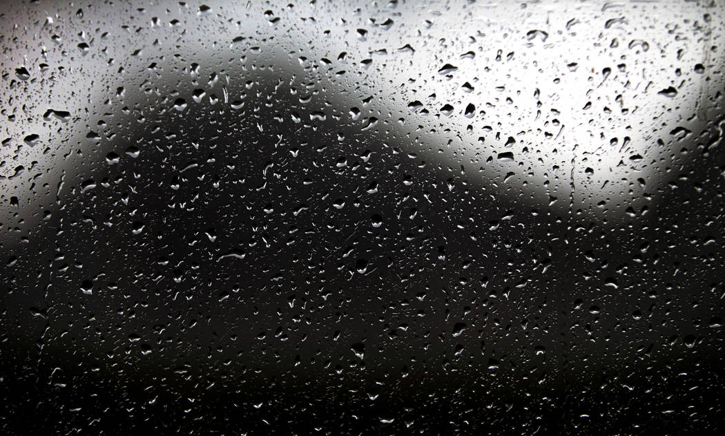Raindrops gather on a window as a fast-moving storm makes its way through the Red Rock Canyon N ...