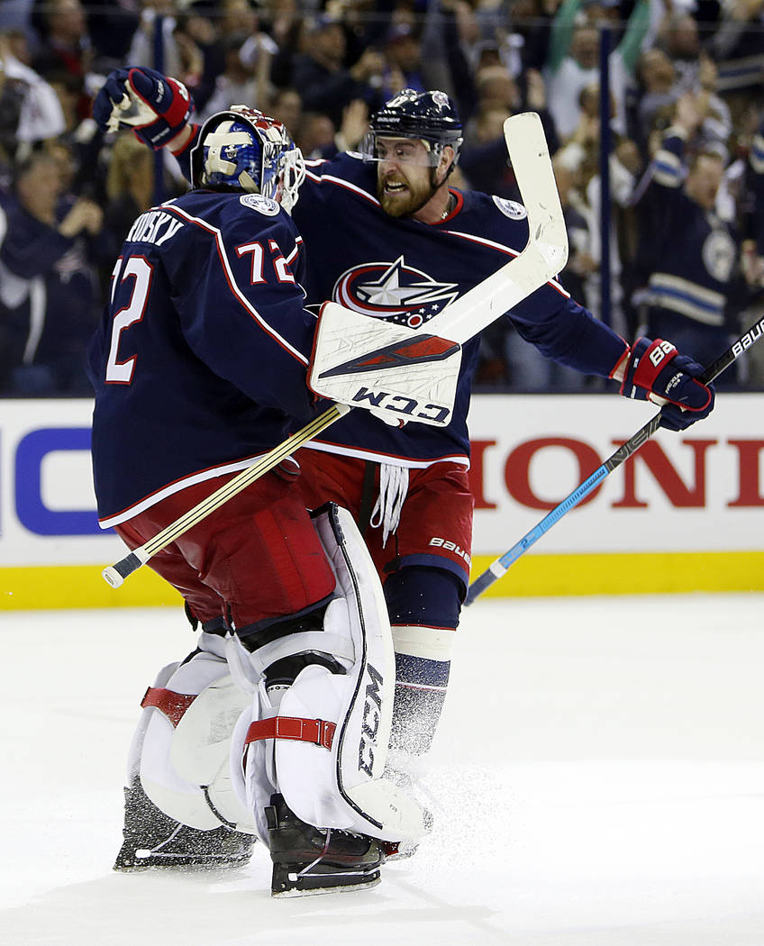 Columbus Blue Jackets' Sergei Bobrovsky, left, of Russia, and Brandon Dubinsky celebrate their ...